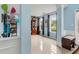 Bright living space with light blue walls, tile flooring, built-ins, and lots of natural light from the windows at 570 White Stag Ct, Suwanee, GA 30024