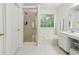 Bright main bathroom featuring a soaking tub, walk-in shower, and white vanity at 570 White Stag Ct, Suwanee, GA 30024
