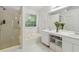 Bright main bathroom featuring dual sinks, a soaking tub, and a walk-in shower at 570 White Stag Ct, Suwanee, GA 30024