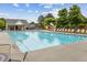 Bright outdoor community swimming pool with a playground and many lounge chairs in the background at 570 White Stag Ct, Suwanee, GA 30024