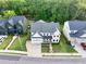 Aerial view showcasing a home nestled in a quiet neighborhood with lush greenery surrounding at 401 Pirkle Ave, Buford, GA 30518