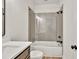 Modern bathroom features a tiled shower-over-tub with glass enclosure and white vanity at 401 Pirkle Ave, Buford, GA 30518