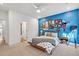 Stylish bedroom showcases vibrant blue accent wall with eclectic decor and natural light at 401 Pirkle Ave, Buford, GA 30518