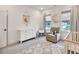 Bright Bedroom with grey rug, crib, comfy armchair, and a white dresser at 401 Pirkle Ave, Buford, GA 30518