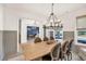 Elegant dining room with a large table, stylish chandelier, and views into other living spaces at 401 Pirkle Ave, Buford, GA 30518