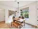 Dining room with a wooden table, bench, and a large window overlooking the backyard at 401 Pirkle Ave, Buford, GA 30518