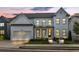 Charming white brick home with a covered porch, well-manicured lawn, and a two-car garage at 401 Pirkle Ave, Buford, GA 30518