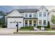 Elegant two-story home with a manicured lawn, a covered front porch, and a driveway at 401 Pirkle Ave, Buford, GA 30518