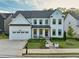 Well-manicured front yard leads to a stylish two-story home with a welcoming covered porch at 401 Pirkle Ave, Buford, GA 30518