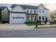 Charming two-story home with a bright white facade, covered porch, and attached two-car garage at 401 Pirkle Ave, Buford, GA 30518