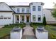 Charming two-story home featuring a welcoming front porch, a well-manicured lawn, and a paved walkway at 401 Pirkle Ave, Buford, GA 30518