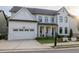 Beautiful two-story home boasting a white exterior, covered porch, and attached two-car garage at 401 Pirkle Ave, Buford, GA 30518