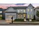 Stunning two-story home featuring white brick, modern design, and manicured front yard landscaping at 401 Pirkle Ave, Buford, GA 30518