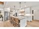 Open concept kitchen with stainless steel appliances and an island with seating at 401 Pirkle Ave, Buford, GA 30518