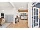 Open-concept living room featuring hardwood floors, neutral paint, and an open doorway to another room at 401 Pirkle Ave, Buford, GA 30518