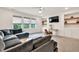 Spacious living room includes a plush sectional sofa, built-in shelves, and a large TV at 401 Pirkle Ave, Buford, GA 30518
