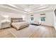 Bright main bedroom with decorative rug, large bed, and views from the double windows at 401 Pirkle Ave, Buford, GA 30518