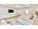 Bright main bedroom featuring a tray ceiling, large bed, and a wall-mounted television at 401 Pirkle Ave, Buford, GA 30518