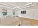 Bright main bedroom featuring a tray ceiling, large bed, and a sitting area at 401 Pirkle Ave, Buford, GA 30518