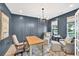 Comfortable home office with dark blue walls, natural light, and seating areas for work or relaxation at 401 Pirkle Ave, Buford, GA 30518