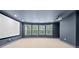 Finished basement featuring plush carpeting, recessed lights, projector, and multiple windows for ample natural light at 2040 Bloomfield Ct, Cumming, GA 30041