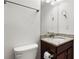 Well-lit bathroom featuring a granite countertop and dark wood cabinets at 2040 Bloomfield Ct, Cumming, GA 30041