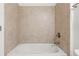 Bathtub featuring beige tiling at 2040 Bloomfield Ct, Cumming, GA 30041