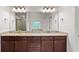 Primary bathroom features a double vanity with granite countertop and dark wood cabinets at 2040 Bloomfield Ct, Cumming, GA 30041