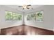 Bright and airy bedroom features hardwood floors, large windows, and a ceiling fan at 2040 Bloomfield Ct, Cumming, GA 30041