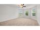 Large bedroom with neutral carpet, ceiling fan, and bright, sunny windows at 2040 Bloomfield Ct, Cumming, GA 30041