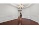 Spacious dining room with beautiful wainscoting and gleaming hardwood floors at 2040 Bloomfield Ct, Cumming, GA 30041