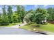 Well-manicured front yard with mature trees and landscaping adds curb appeal at 2040 Bloomfield Ct, Cumming, GA 30041