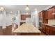 Gourmet kitchen with granite island, stainless appliances, and open floorplan with hardwood floors throughout at 2040 Bloomfield Ct, Cumming, GA 30041