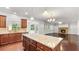 Gourmet kitchen with large island and stainless appliances, offers an open flow into a living area with fireplace at 2040 Bloomfield Ct, Cumming, GA 30041