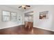 Well-lit living room with hardwood floors offers a seamless transition to the sunroom and kitchen at 2040 Bloomfield Ct, Cumming, GA 30041