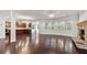 Expansive living room boasts hardwood floors, a stone fireplace, and seamless flow into the modern kitchen at 2040 Bloomfield Ct, Cumming, GA 30041