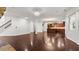 Open-concept living room with hardwood floors offers seamless transition to the kitchen and staircase at 2040 Bloomfield Ct, Cumming, GA 30041