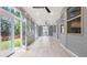 Bright sunroom with many windows and tile flooring offers an abundance of natural light and outdoor views at 2040 Bloomfield Ct, Cumming, GA 30041