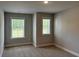 Bedroom featuring two windows allowing natural light with gray carpet at 2405 Malster Ln, Lawrenceville, GA 30043