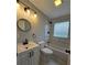 Modern bathroom featuring marble-style tiles, vanity with lights, and a bathtub with a rain shower head at 766 Longleaf Dr, Forest Park, GA 30297