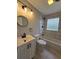 Modern bathroom featuring marble-style tiles, vanity with lights, and a bathtub with a rain shower head at 766 Longleaf Dr, Forest Park, GA 30297