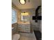 Modern bathroom featuring a stylish vanity, illuminated mirror, and a sleek, tiled shower with a black rain shower head at 766 Longleaf Dr, Forest Park, GA 30297