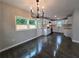 The dining area showcases modern chandelier lighting and offers seamless flow into the updated kitchen at 766 Longleaf Dr, Forest Park, GA 30297
