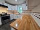 A stunning kitchen features custom wood counters, stainless steel appliances, and stylish white cabinets at 766 Longleaf Dr, Forest Park, GA 30297