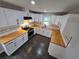 Well-appointed kitchen features white cabinetry, butcher block counters, and modern appliances at 766 Longleaf Dr, Forest Park, GA 30297