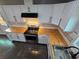 Gorgeous updated kitchen features bright cabinets, butcher block counters, and stainless appliances at 766 Longleaf Dr, Forest Park, GA 30297