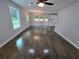 Bright living room boasts sleek dark floors, a modern ceiling fan and ample windows to maximize natural light at 766 Longleaf Dr, Forest Park, GA 30297