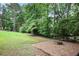 Grassy backyard area with a built-in fire pit at 963 Bolingbrook Sw Dr, Marietta, GA 30064