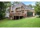 A home with a large backyard and a wooden deck at 963 Bolingbrook Sw Dr, Marietta, GA 30064