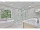 Modern bathroom featuring a glass-enclosed shower, a soaking tub, and updated fixtures at 963 Bolingbrook Sw Dr, Marietta, GA 30064